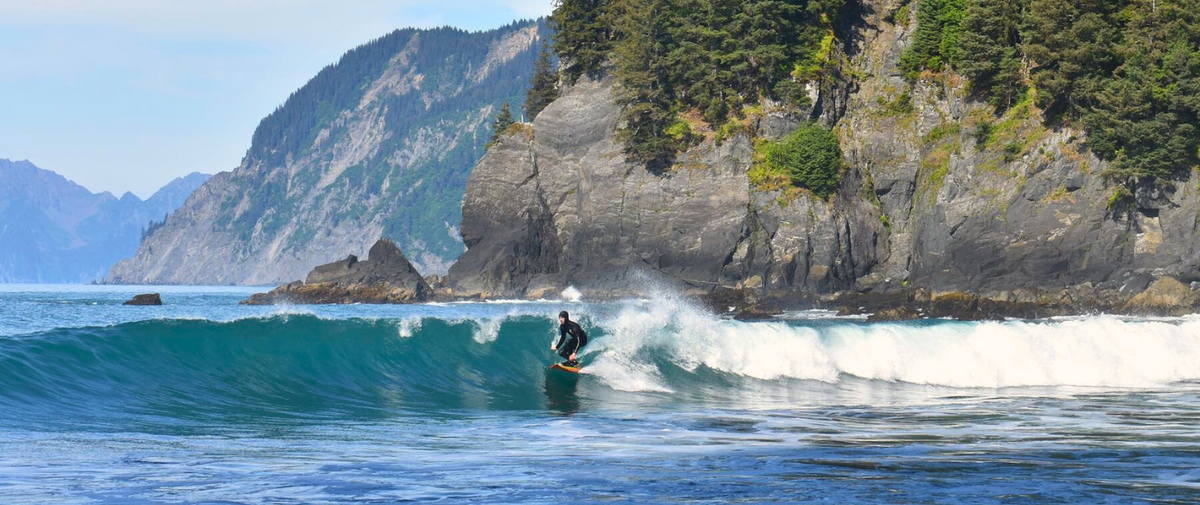Surfer surfing long wave in Vancouver Island